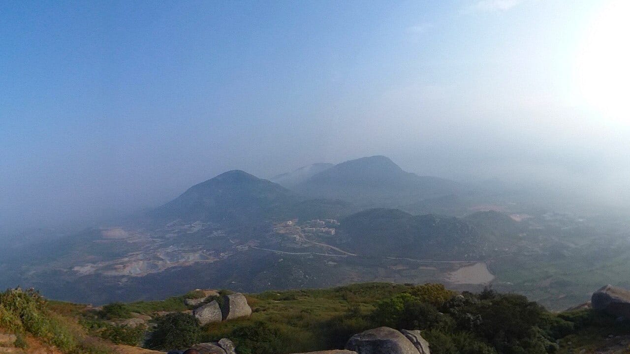 Sunrise from the top of Skandagiri with clouds below the summit
